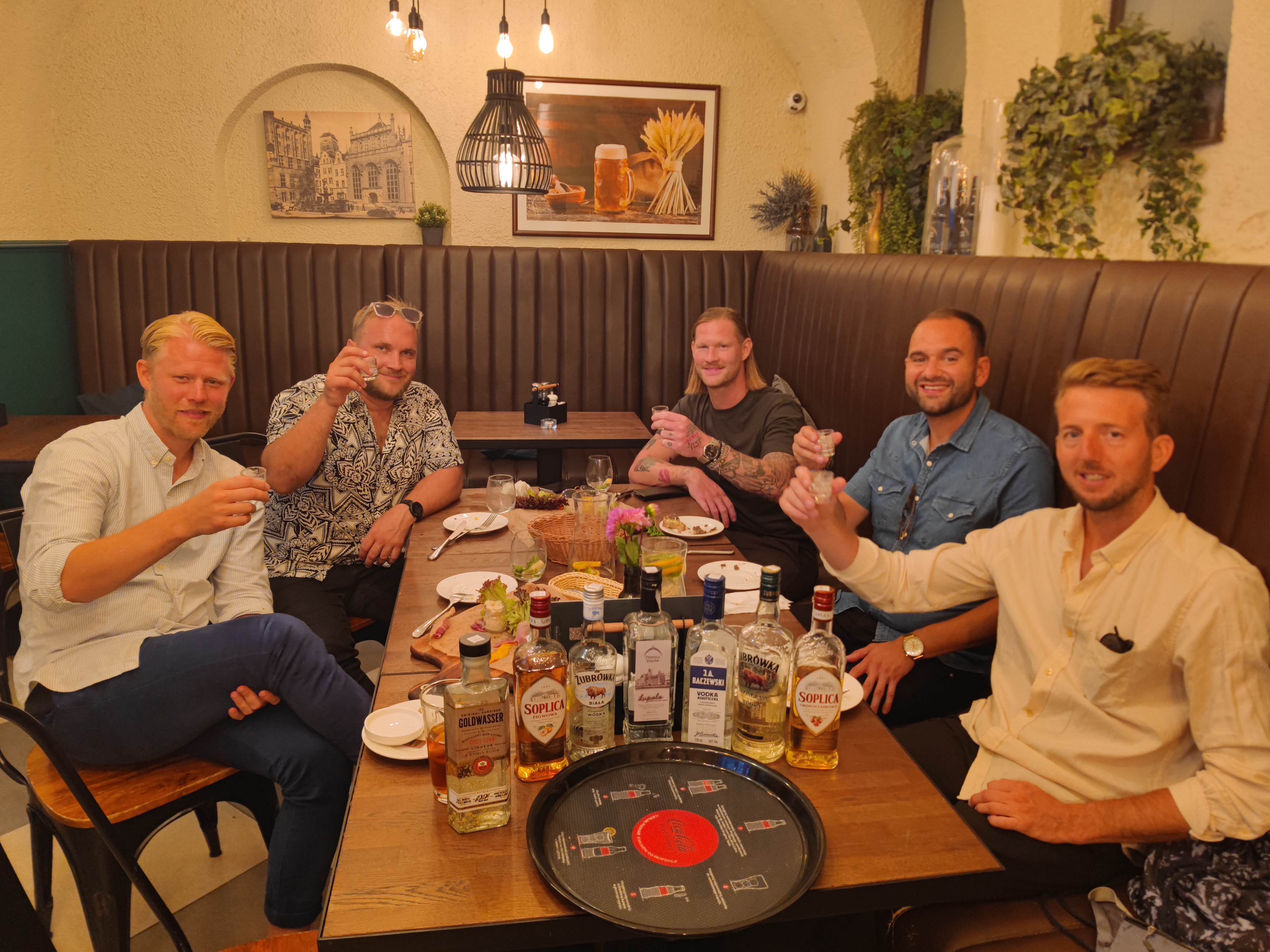 A group of friends enjoying a guided Polish vodka tasting together